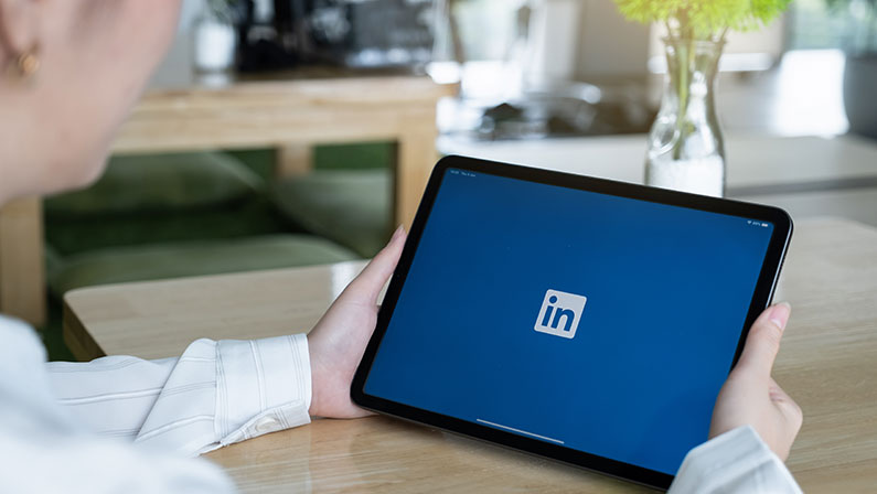 LinkedIn logo on ipad screen. LinkedIn is a social network for search and establishment of business contacts.