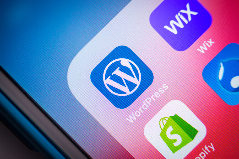 Close up of WordPress icon with other CMS services (Wix, Shopify, Drupal). WordPress is a content management system (CMS)