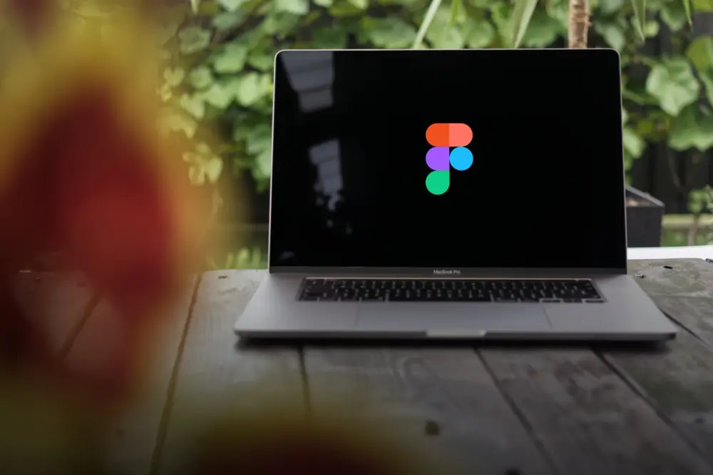 Figma logo, collaborative interface design web application for macOS and Windows, displayed on a MacBook Pro screen