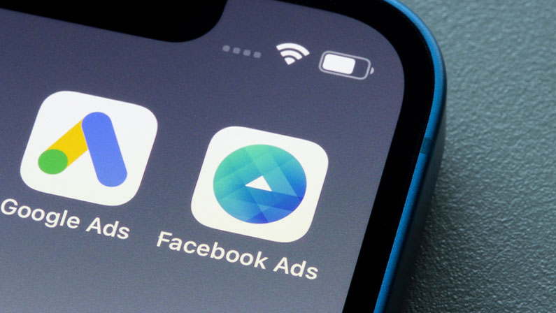 Facebook Ads Manager and Google Ads app icons are seen on an iPhone.