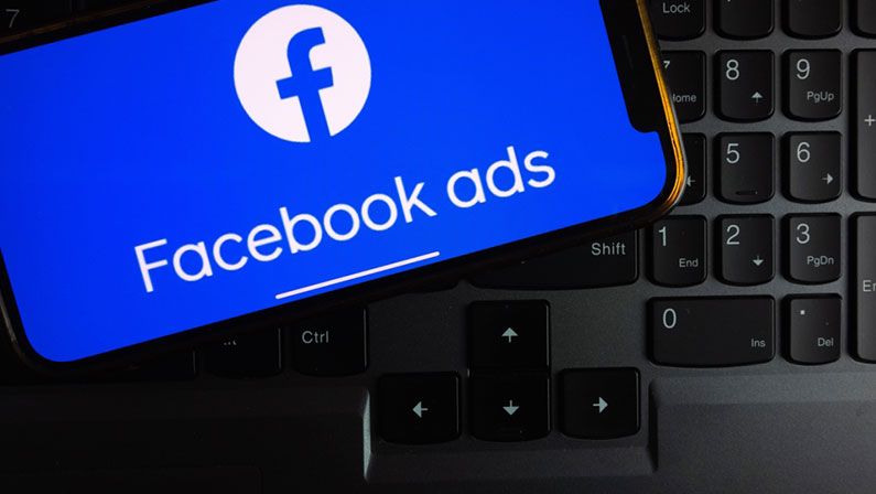 Facebook Ads logo displayed on smartphone screen in the office