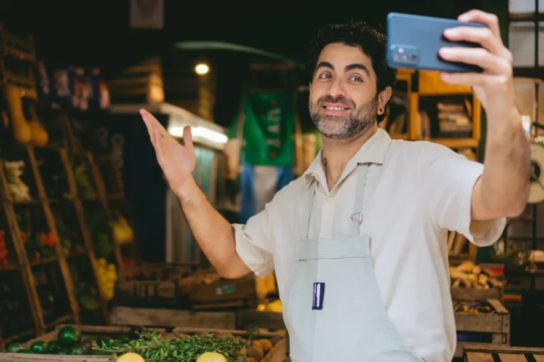 business owner smiling and taking selfie video for social media