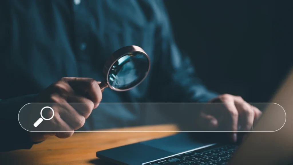 Searching for information in technology with AI systems concept, Businessman holding magnifying glass with command prompt, chat and AI search engine for data by connect to global internet network.