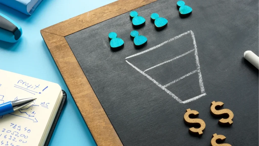 Marketing sales funnel on the blackboard and figurines.