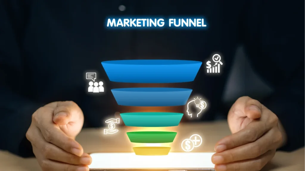 A person is holding a tablet with a marketing funnel on it. The funnel is made up of different colored bowls, each representing a different stage of the funnel
