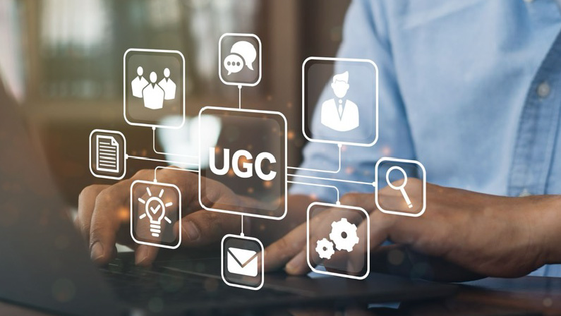 Businessman using a computer to "UGC" abbreviation and icon on laptop computer. User-generated content concept.(UGC) Online marketing concept. Customer create content on social media.
