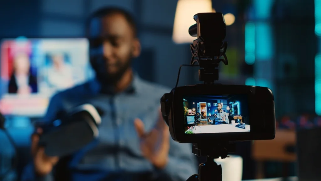 Tech content creator filming technology review of newly released gaming VR glasses for audience. African american influencer showing virtual reality goggles to subscribers