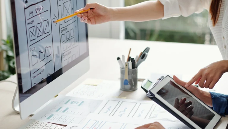 Cropped image of UX and UI designers working on version of website for mobile devices