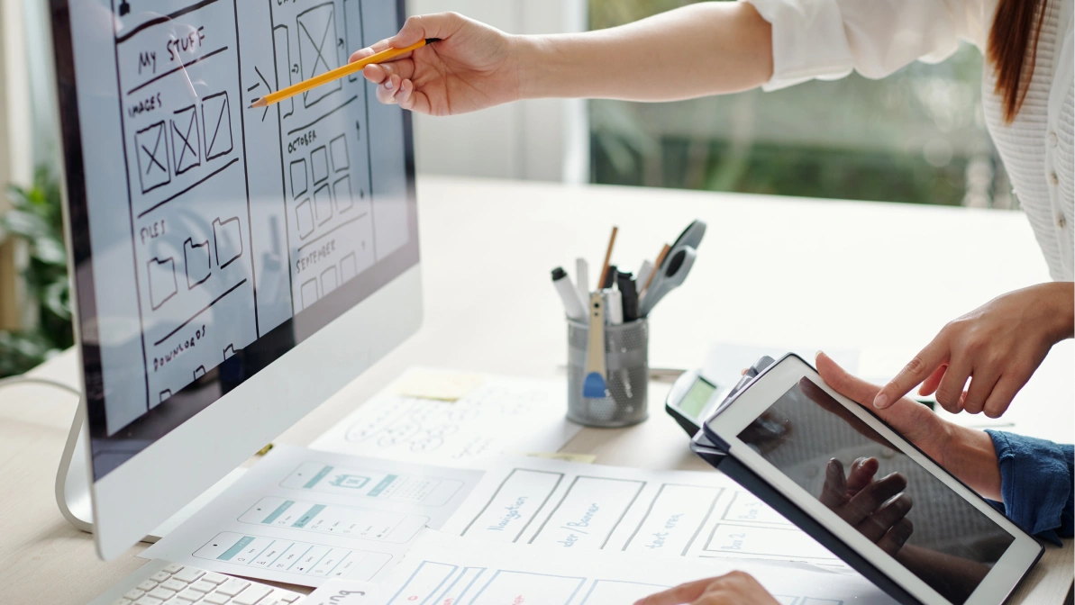 Cropped image of UX and UI designers working on version of website for mobile devices