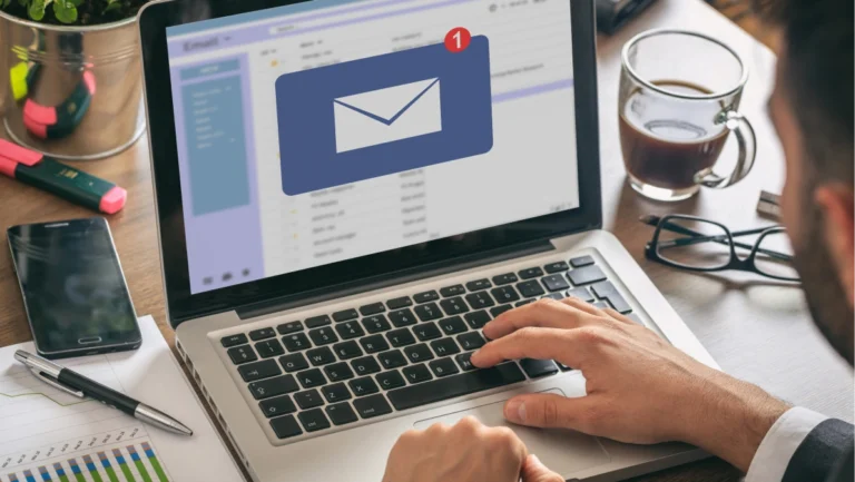 Email notification concept, man working with a computer laptop, one new inbox e mail message on the screen, business office desk background
