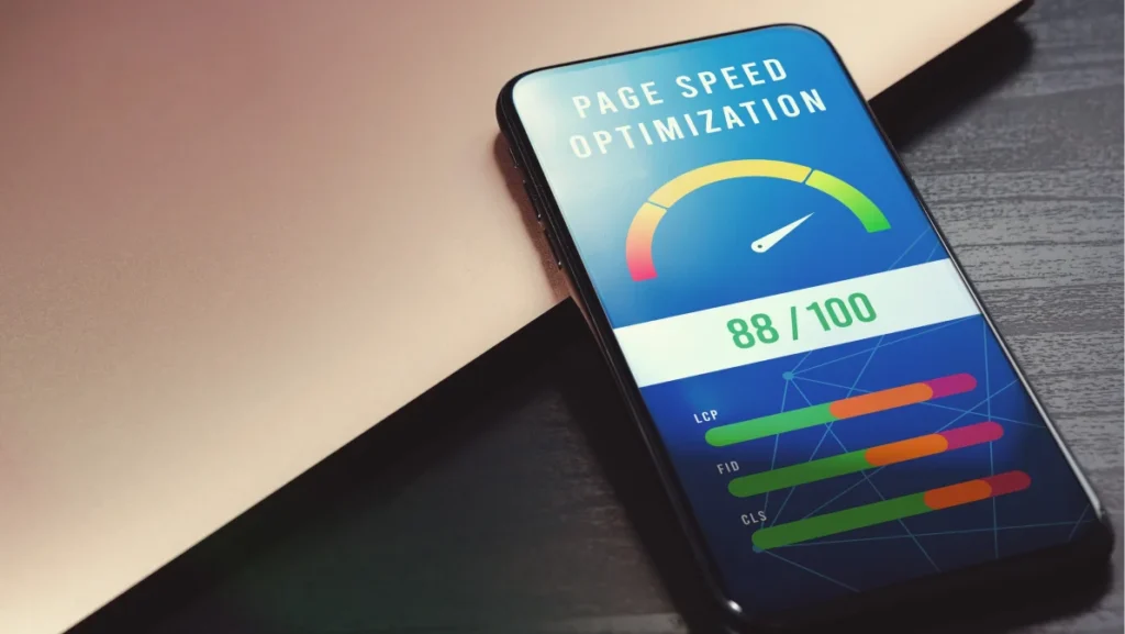 Boost mobile website performance with page speed optimization. High-value accelerometer on phone screen beside laptop on black wooden table for SEO digital marketing visuals