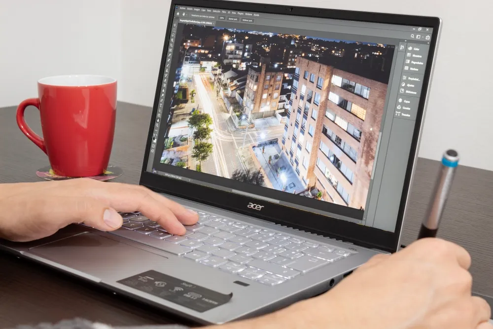 Close up to a photographer working on adobe photoshop software