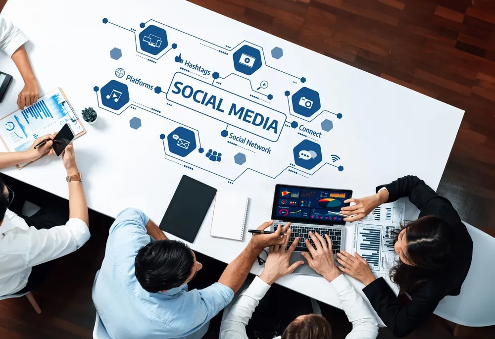 A dynamic workspace showcasing professionals collaborating on social media strategies and data analysis