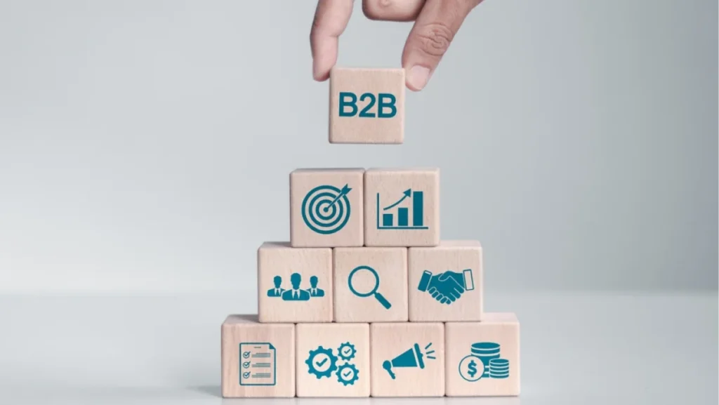 B2B marketing strategy concept. business to business, e-commerce, Professional business and commerce collaboration. Man hand stacking wooden block with B2B icon