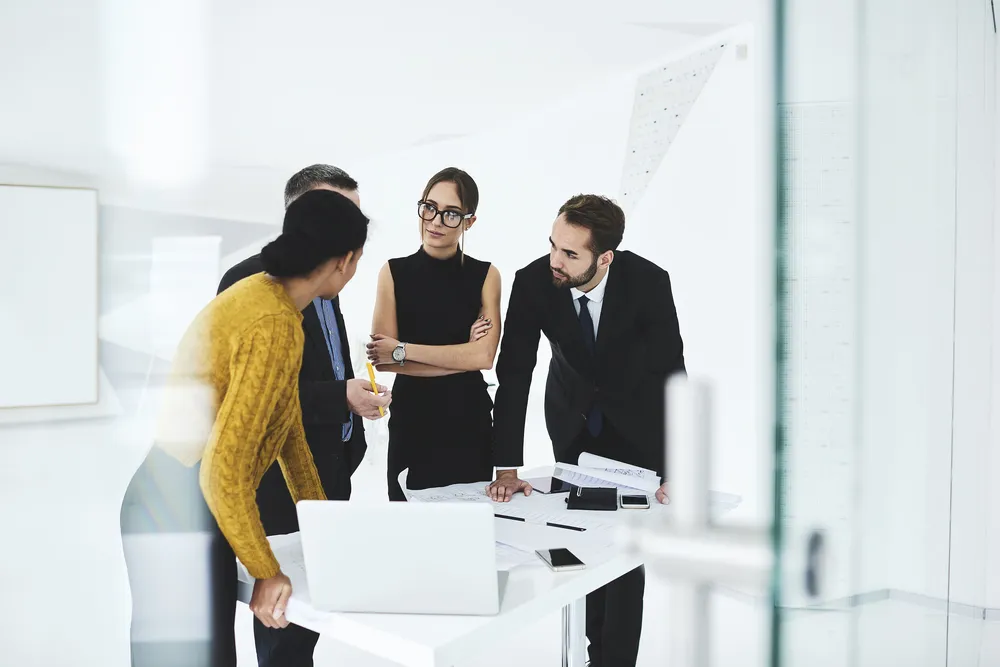 Crew of skilled marketing experts consulting with executive about rebranding