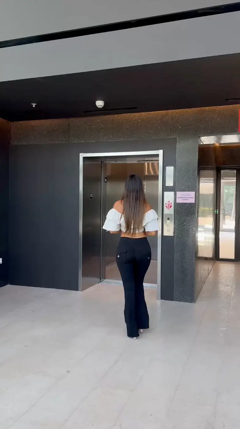 woman walking into elevator