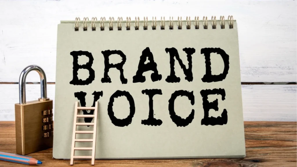 Brand Voice. Green notepad on wooden texture table and white background.