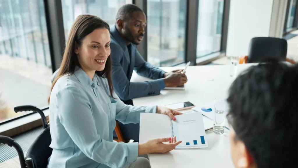Successful businesswoman leading meeting with diverse business team in office