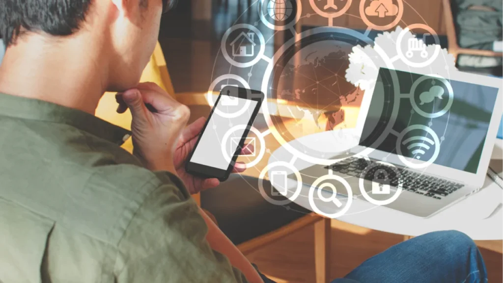 A man using smartphone with IOT, internet of things conceptual sign