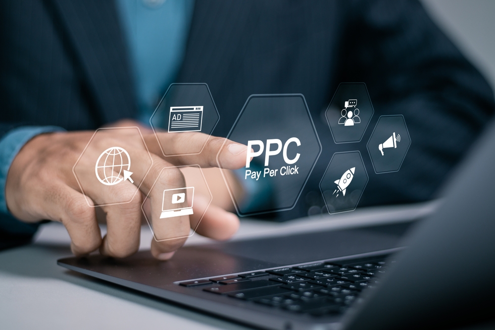 Digital Marketing Strategies and Goals. Businessman using laptop with PPC icon on virtual screen