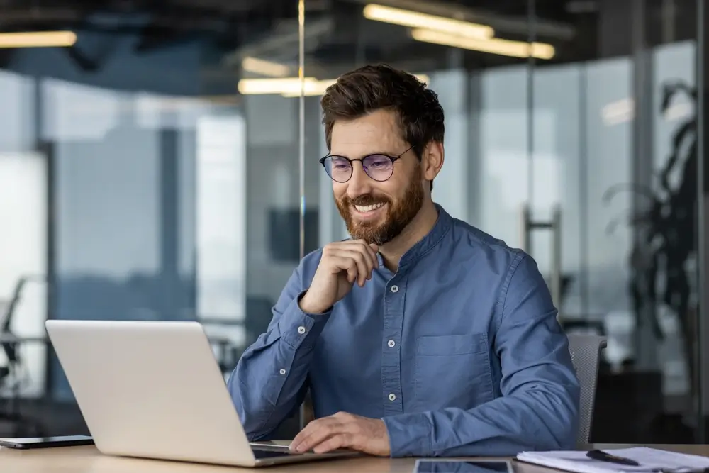 business man working on laptop at desk