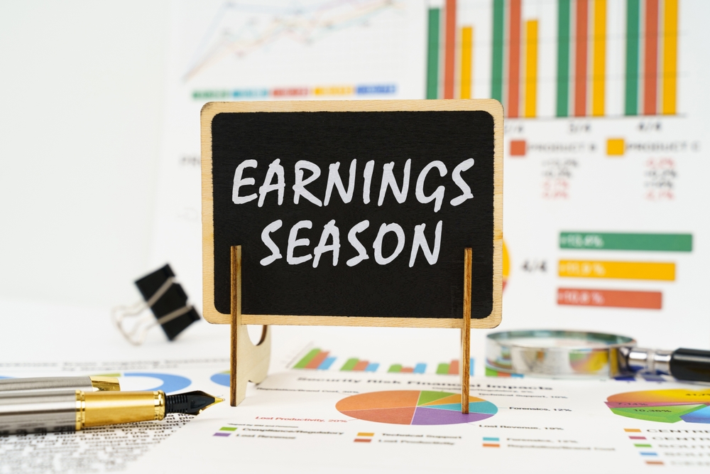 Against the background of business graphs, a board with the inscription - Earnings Season