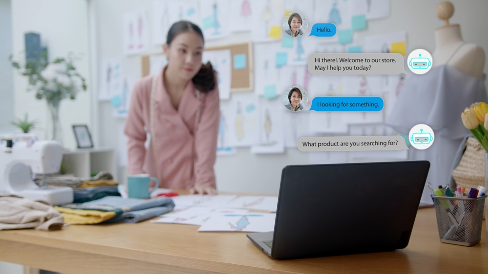 A woman in her office looking at her laptop chatbot messages