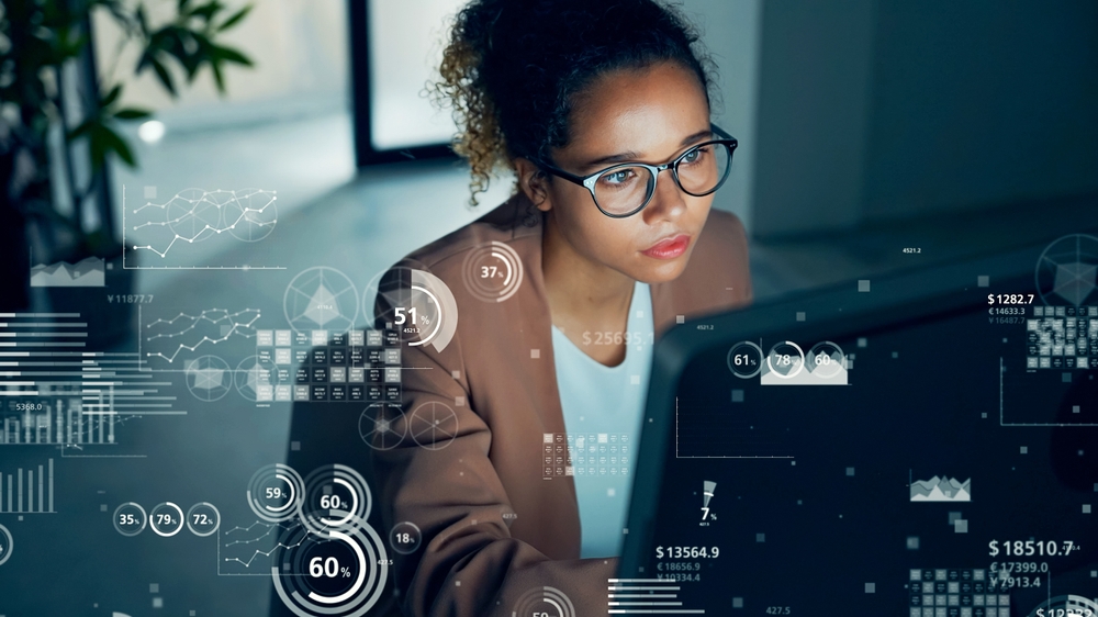 Conceptual visual of data analysis with a woman working in the office