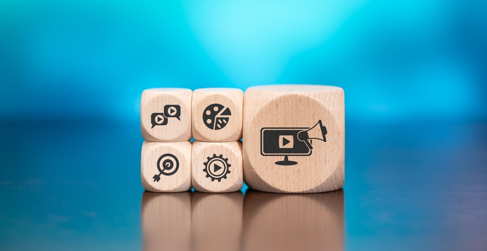 Wooden blocks with symbol of video marketing