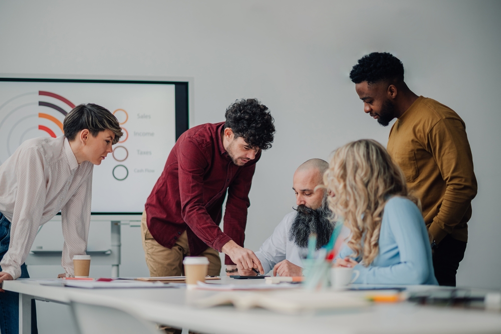 Marketing professionals gathering around a table