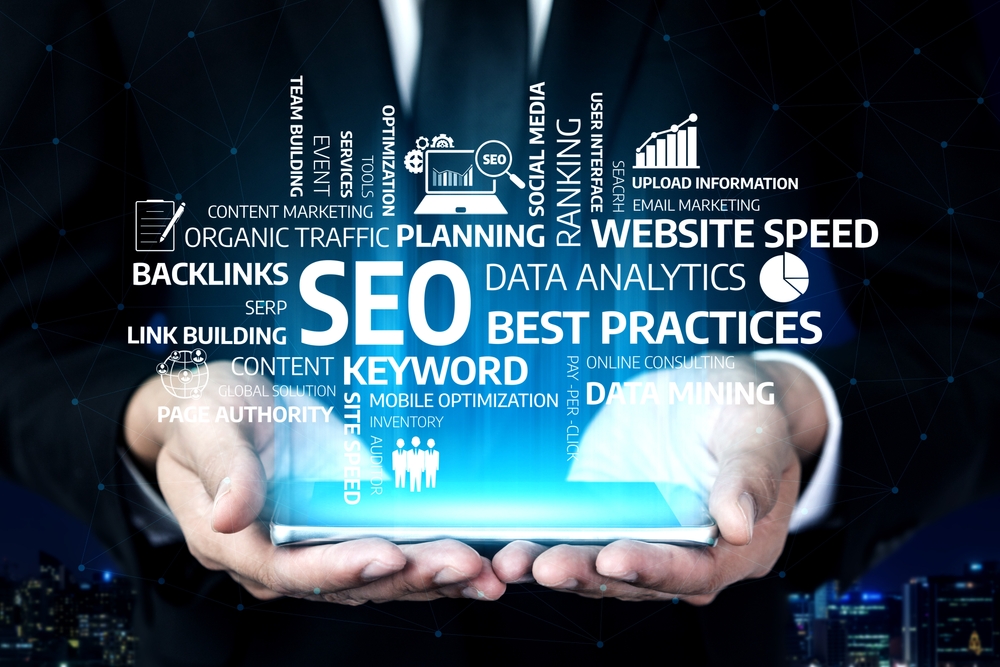 A visually engaging image showcasing hands holding a digital interface filled with SEO terms