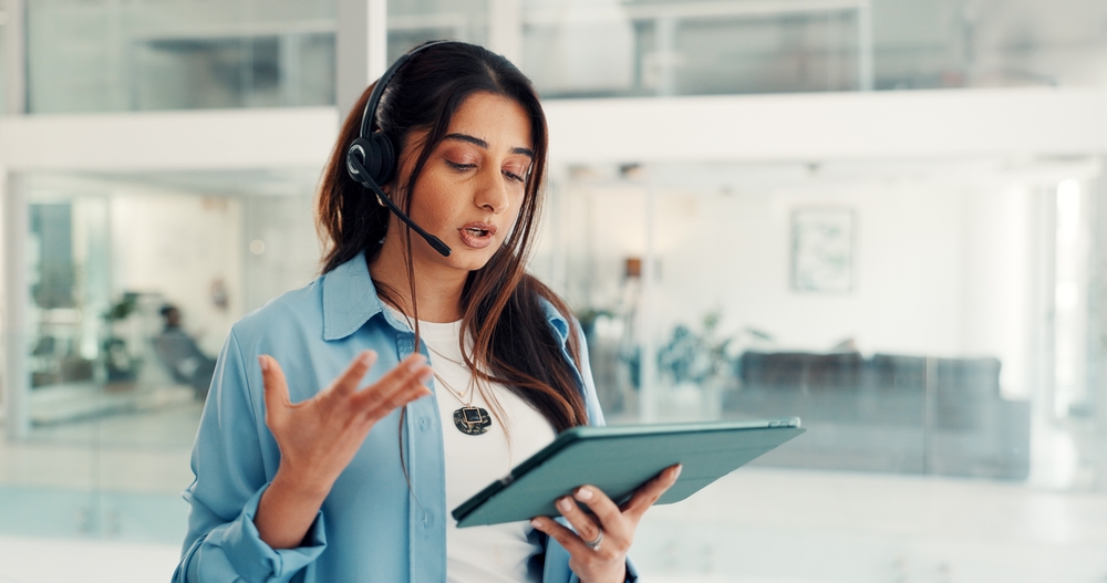 Headset, telemarketer and woman with tablet, call center or talking with contact for lead generation