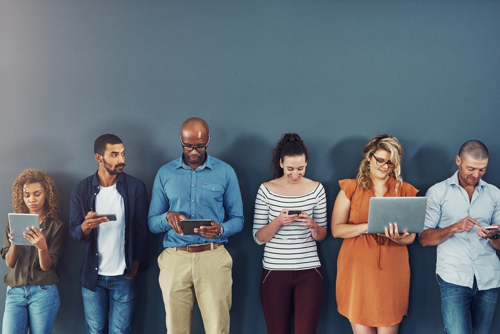 Technology, connectivity and team of business people at wall together on phone, tablet or laptop