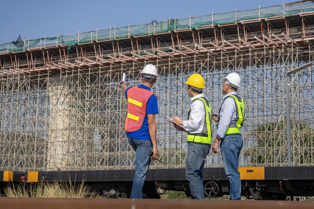Construction supervisors reviewing project progress at infrastructure site