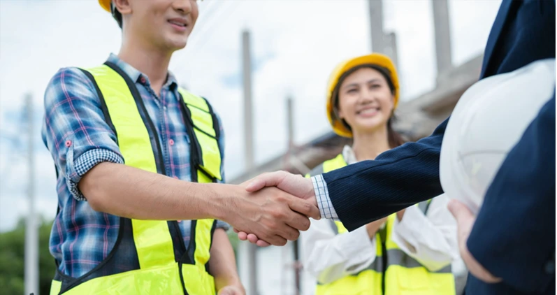 Foreman or Civil engineer handshake making modern construction. industry professional team and engineer concept