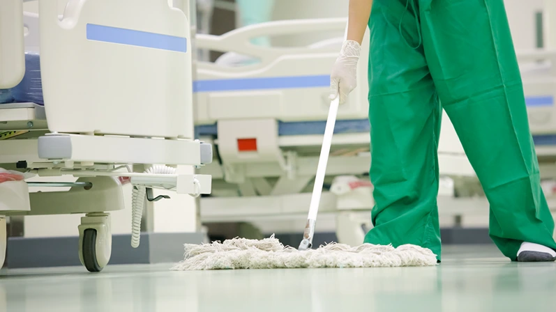Professional office cleaner is holding Mop Hospital cleaning staff, hospital beds,Cleaning the hospital floor,Cleaner