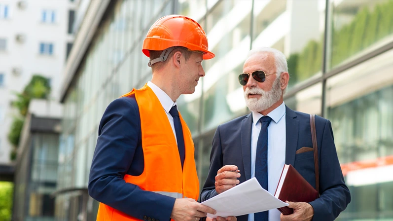 Engineer man discussing something with senior business man
