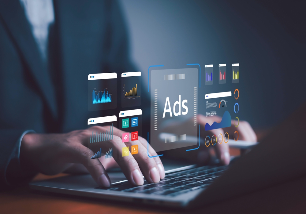 Businessman using laptop with digital advertising dashboard
