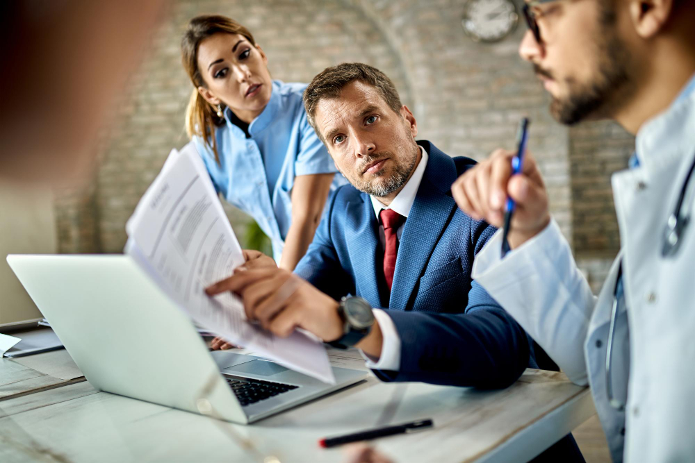 Mid adult businessman and group of doctors