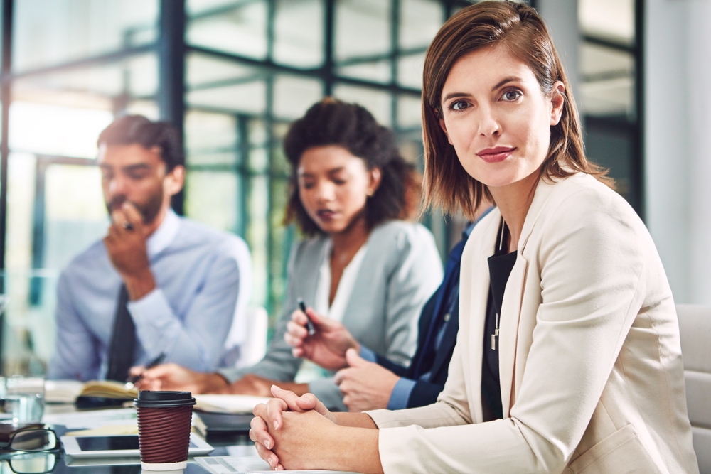 Portrait, meeting and woman in office with business people, confidence and consultant at law firm.