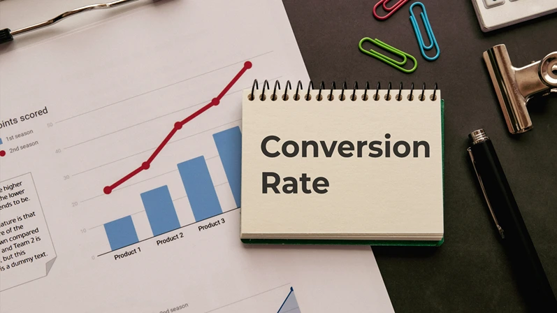 There is notebook with the word Conversion Rate. It is as an eye-catching image.