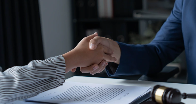 Lawyer and client shaking hand.