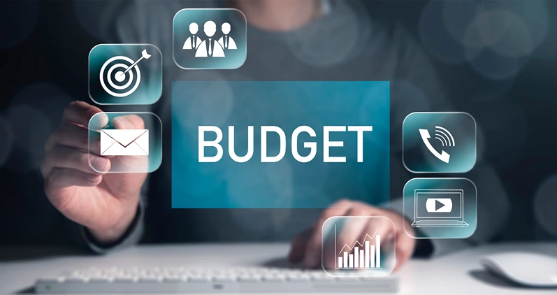 budget text on virtual screen with worker working in computer