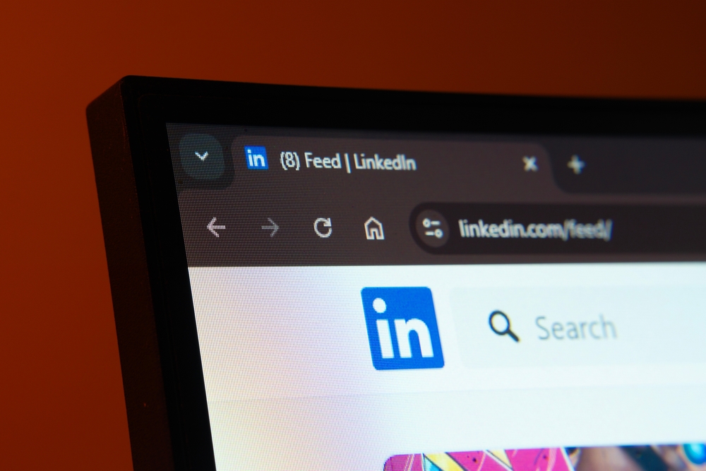 Close-up of a computer screen displaying the LinkedIn web interface in dark mode
