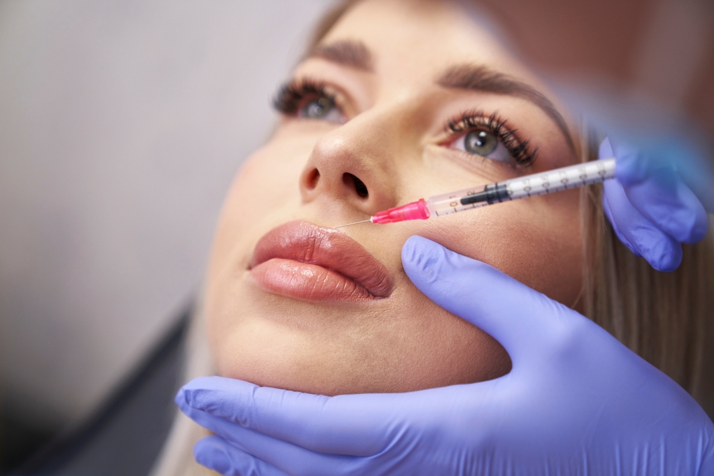 Woman having facelifting procedure in beauty salon