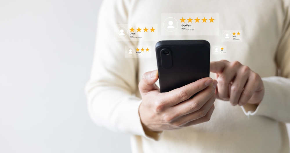 close up customer man hand hold smartphone to read comment on travel website and check survey online