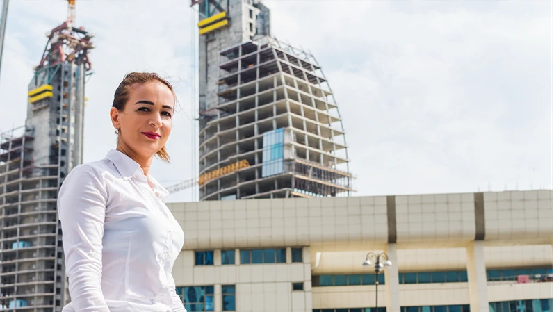 successful business woman on the background of a building under construction