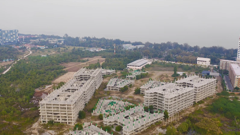 Aerial top view of abandoned apartment or hotel under construction site with structure. Top view of precast concrete slap floor. Development architecture buildings.