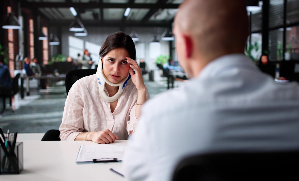 Unhappy Man Consults Lawyer For Workers' Compensation Case Meeting.