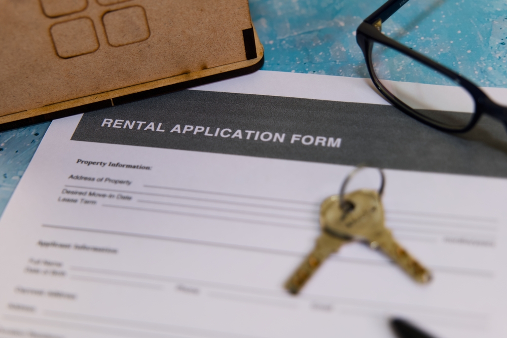 A close-up view of a rental application form with keys 